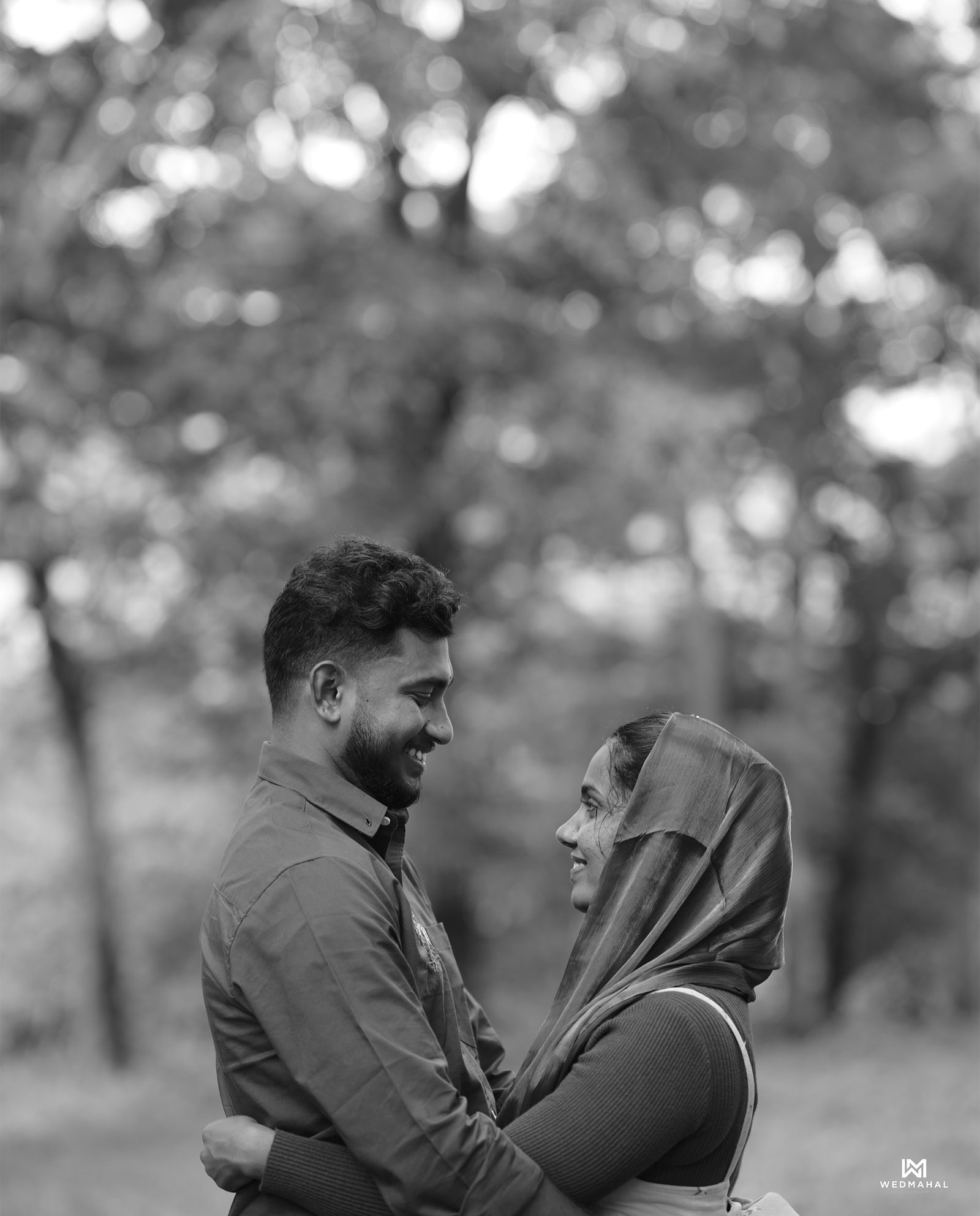 A groom kissing his smiling bride on the forehead